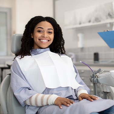 Woman smiling while sitting in treatment chair