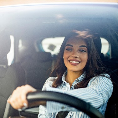 Woman smiling while driving home