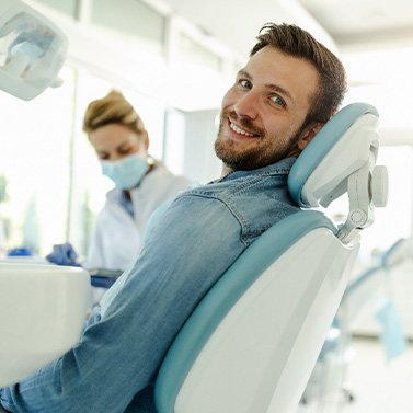 Man smiling while sitting in treatment chair