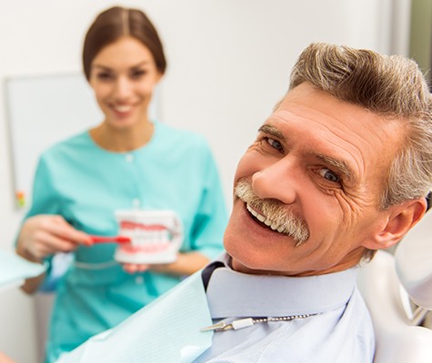 Older man smiling in dental chair