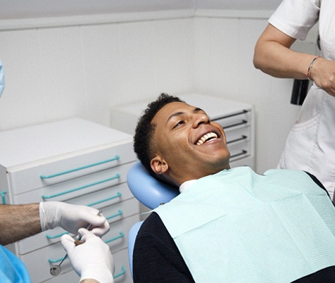 Man in dental chair at cosmetic dentist.