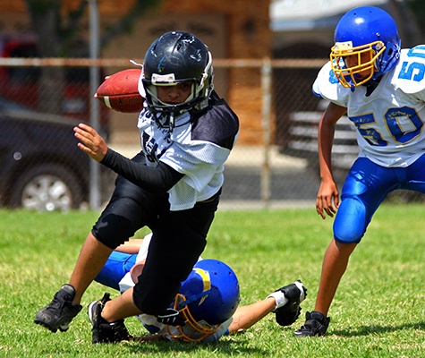 Kids playing football with athletic mouthguards