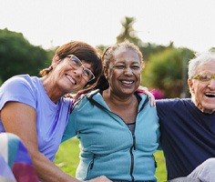 mature friends with dentures smiling and talking