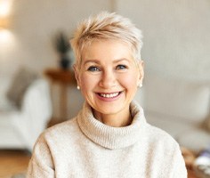 a mature woman smiling with dentures