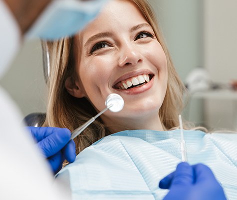 Woman visiting the dentist for checkup to prevent dental emergencies