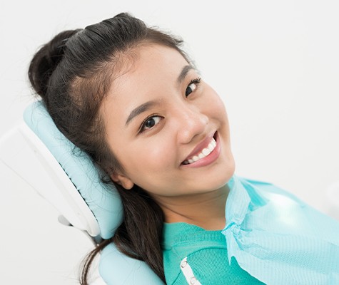 Woman smiling after tooth extractions