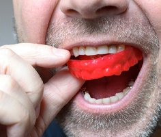 man wearing a red mouthguard