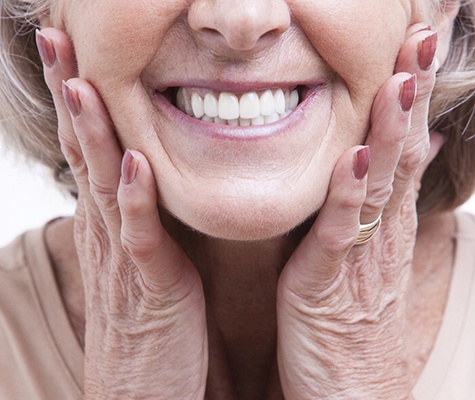 Closeup of smiling woman with dental implant-dentures in Lancaster