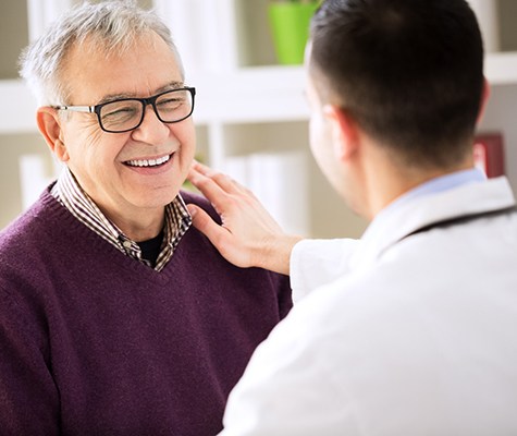 Lancaster dental implant dentist talking with patient about dental implant dentures