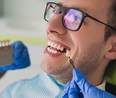 Smiling young man getting dental implants in Lancaster