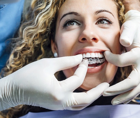 Young woman smiles while getting Invisalign in Lancaster