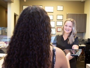 receptionist smiling at patient in Lancaster