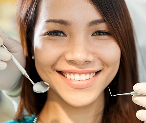 Woman smiling during dental checkup and teeth cleaning visit