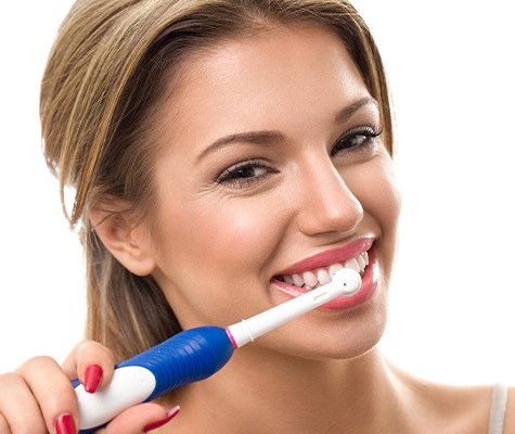 Woman using at home dental hygiene products