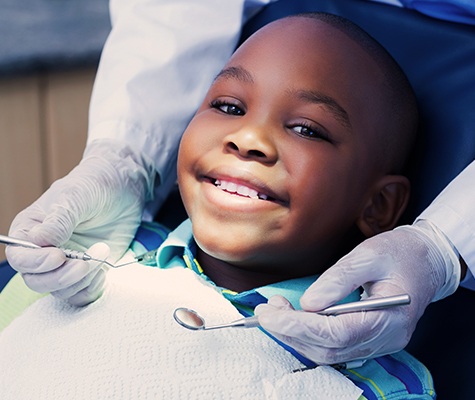 Child smiling during children's dentistry visit