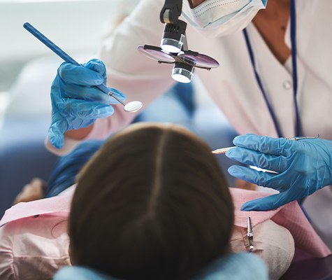 Dentist performing teeth in a day surgery