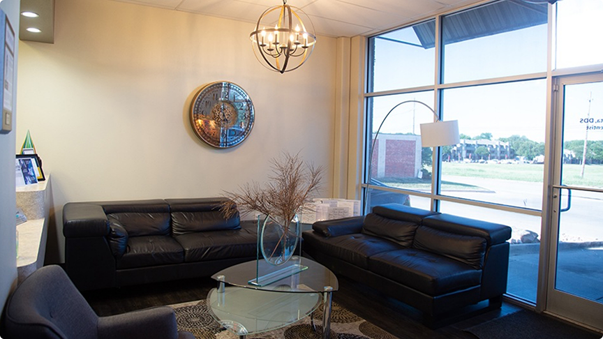 Couches, wall clock, and windows in waiting room