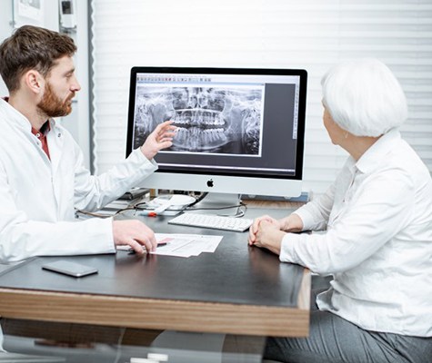 dentist showing a patient their dental x-rays 