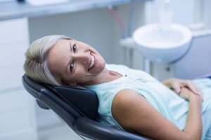 A smiling woman in the dental chair.