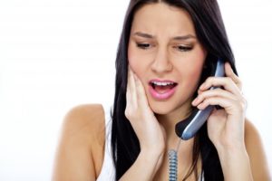 pained woman calling her Lancaster emergency dentist