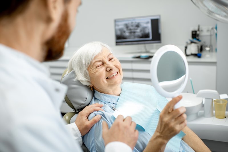 senior woman smiling with dental implants