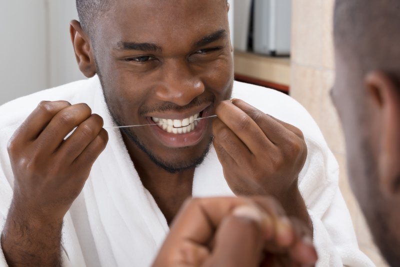 man flossing in Lancaster to prevent health issues