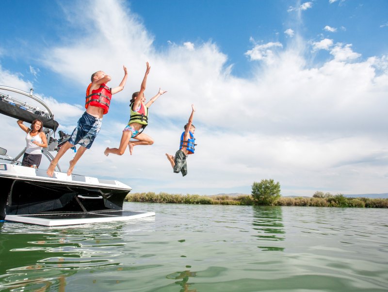 a bunch of people diving into the water