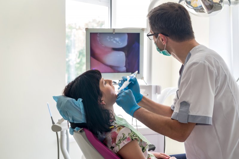 A dentist checking his patient's mouth before committing to dental implant surgery