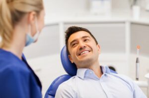 Man smiling during his dental visit after years of not going
