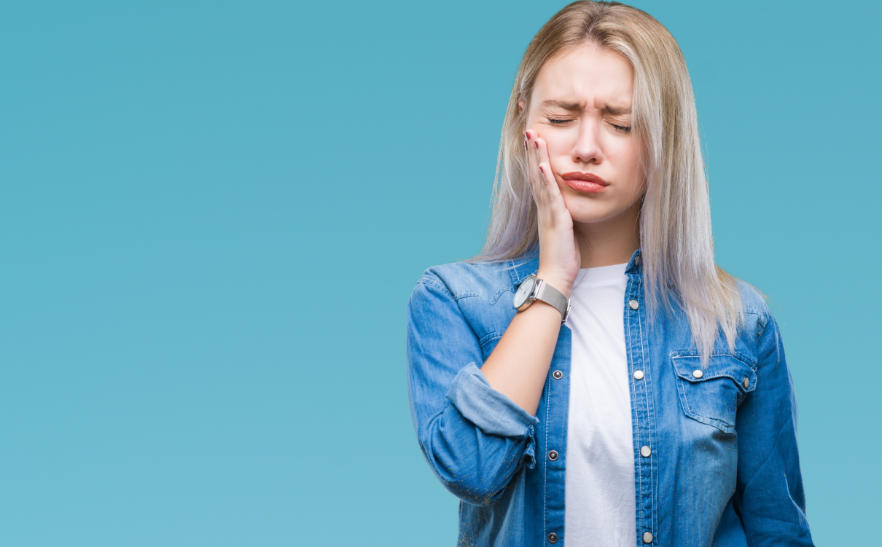Woman holding jaw in pain