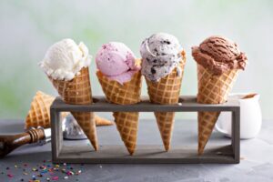 Four ice cream cones on a table