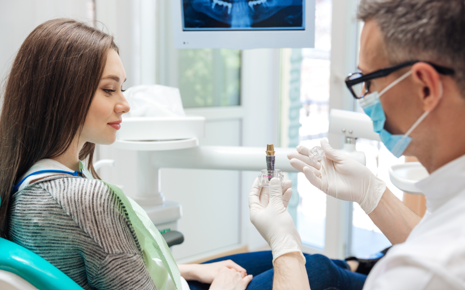 Dentist showing patient dental implant